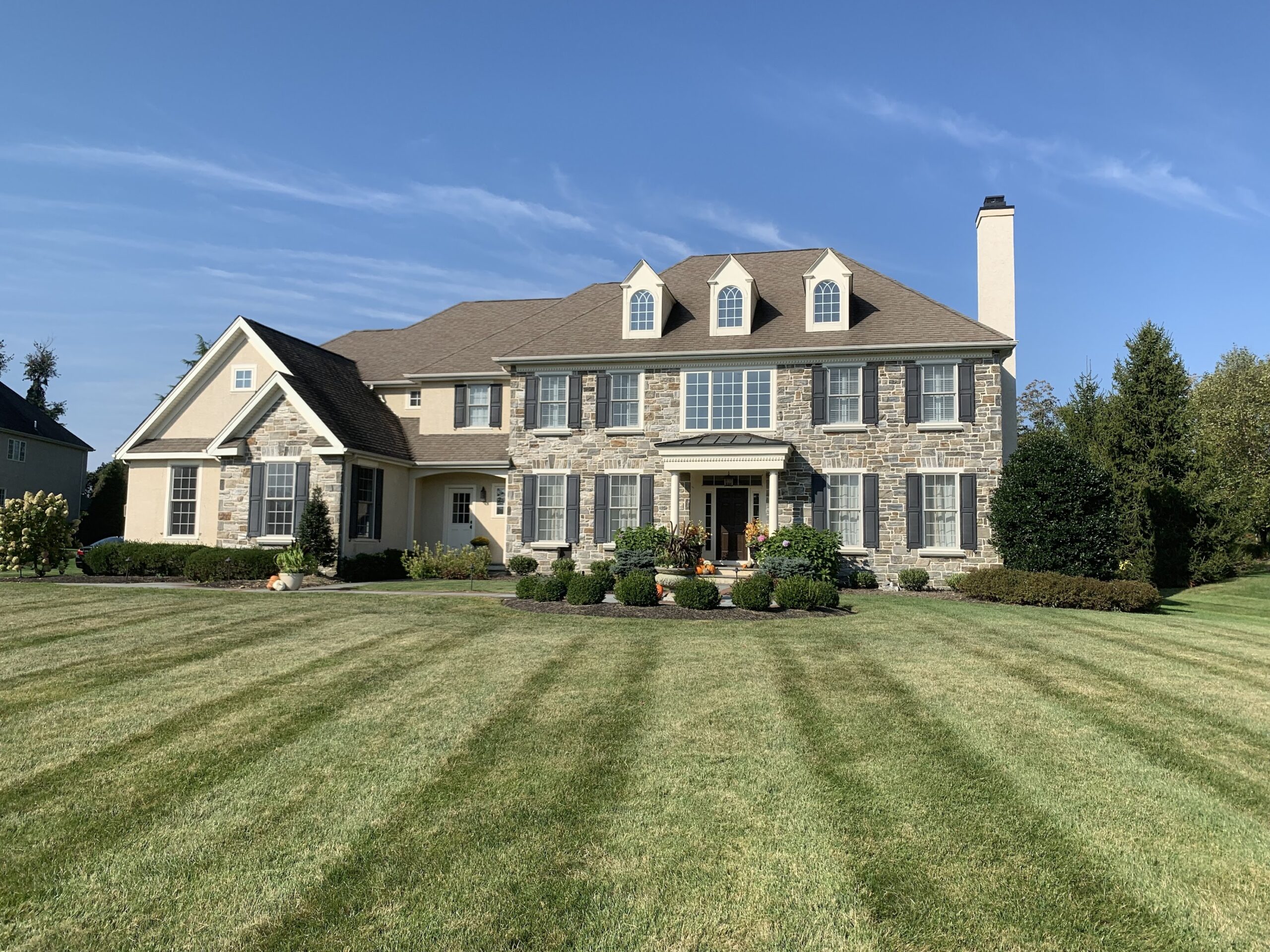 Large home with front yard landscaping